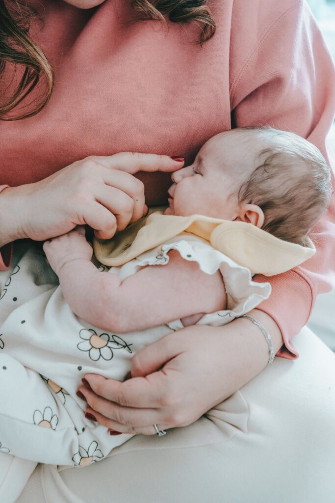 Baby falling asleep on mom's lap