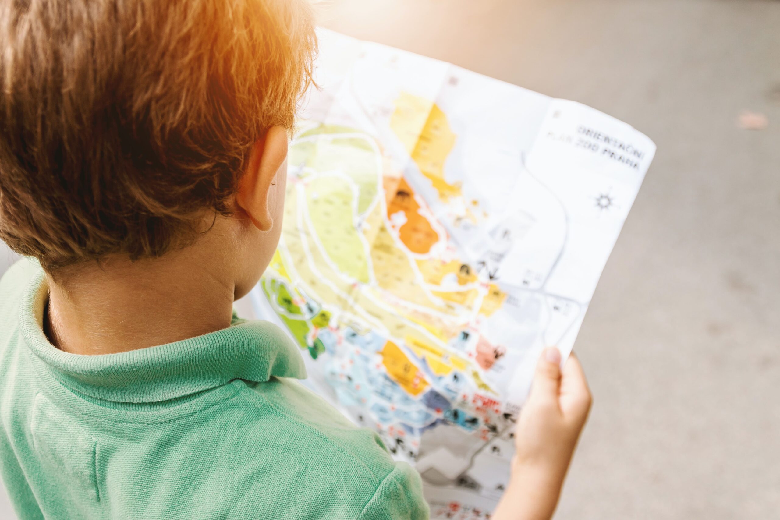 Child wandering around with a map in a children's museum