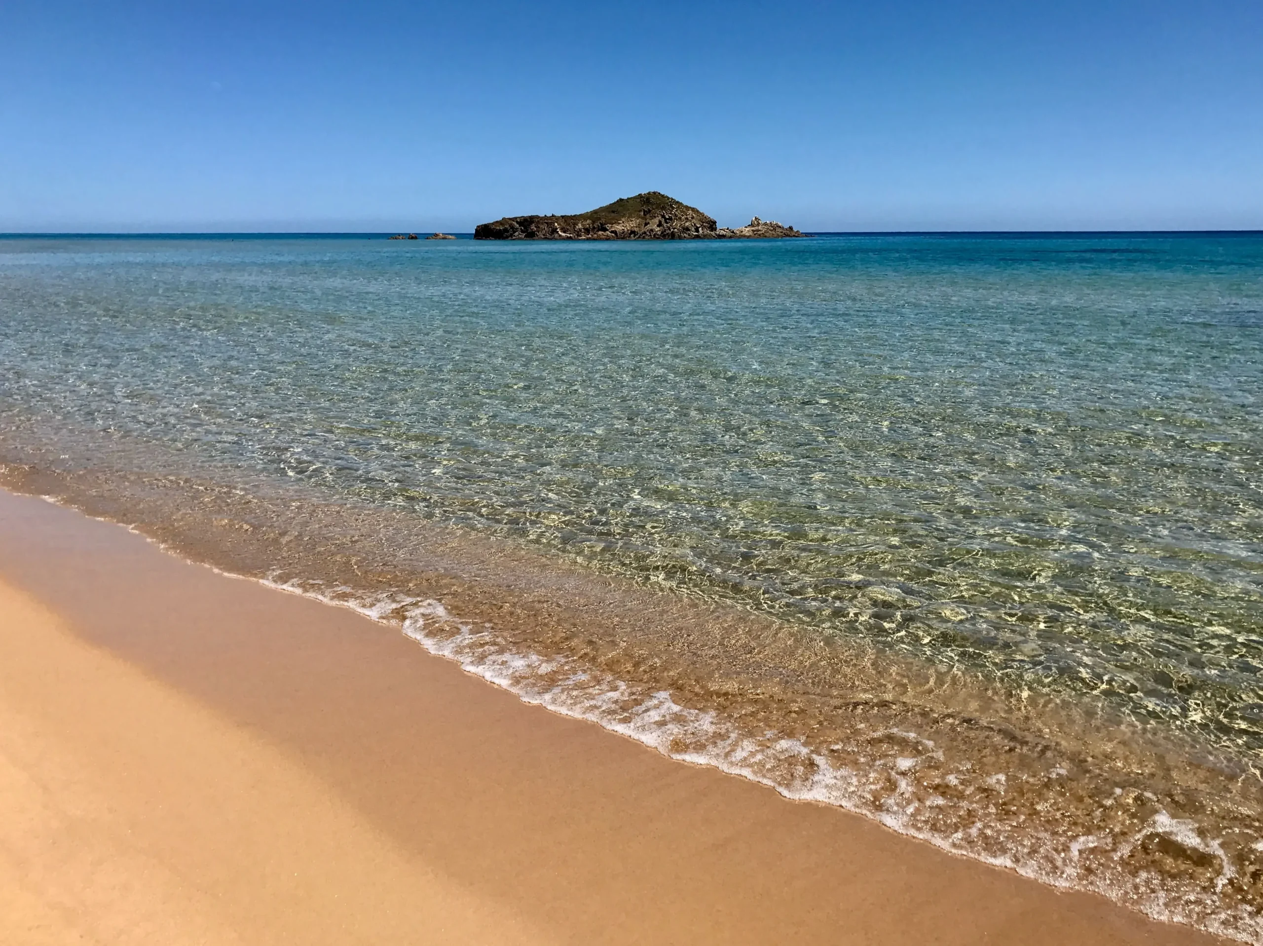 View of a magnificent Cagliari beach. You can see the rocks and the deep blue water.